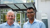 Owasim Akram and Joe Devine in front of some green trees on the Örebro University campus.